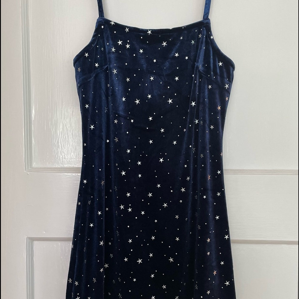 Blue stretch velvet dress with silver stars. Has adjustable straps. Size S